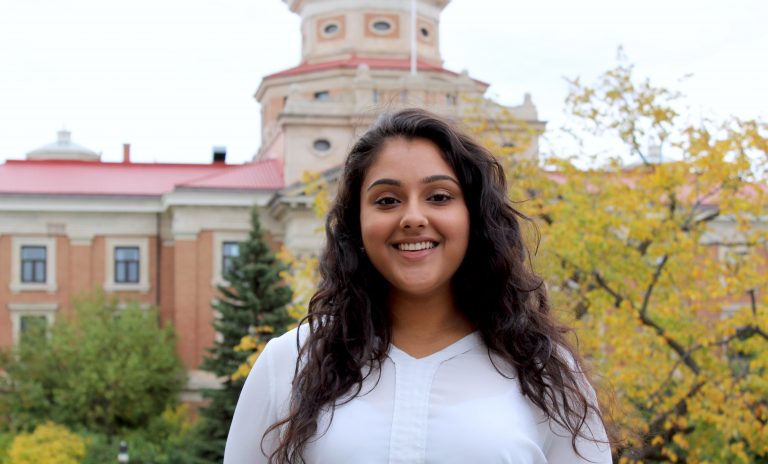 Photo of UMSU president Tanjit Nagra in front of the University of Manitoba's administration building.