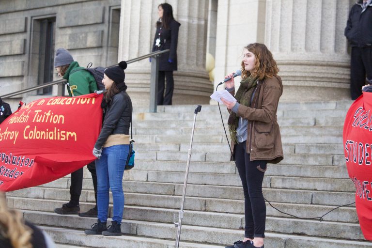 Photo of UMSAN member Elizabeth McMechan speaking at a tuition hike protest at the Manitoba Legislature.