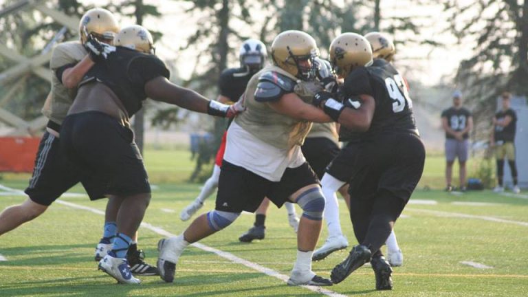 Ryan Wengelinski makes a block during Bison football training camp 2017.