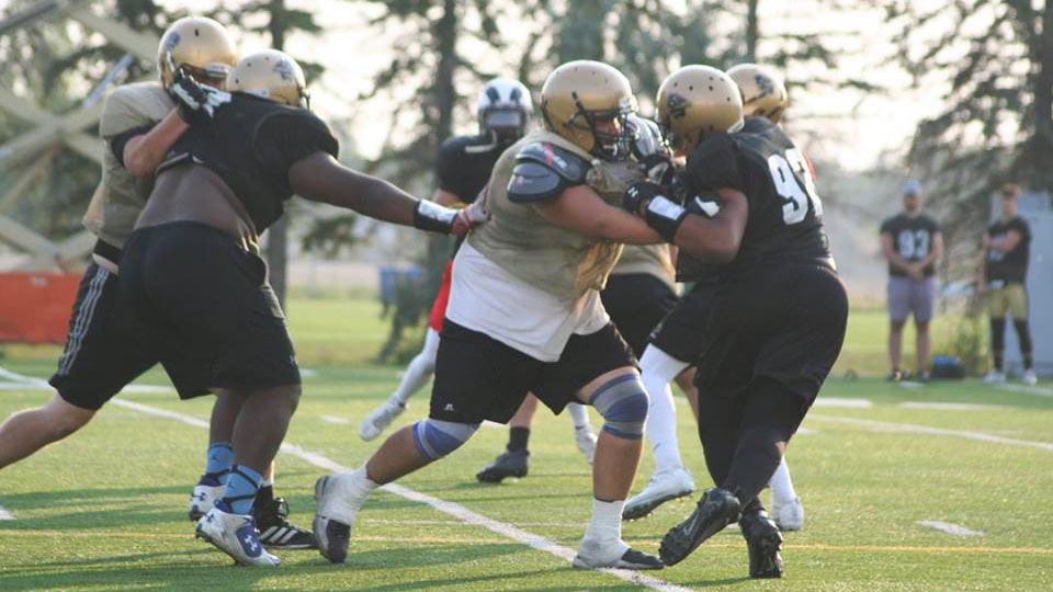 Ryan Wengelinski makes a block during Bison football training camp 2017.