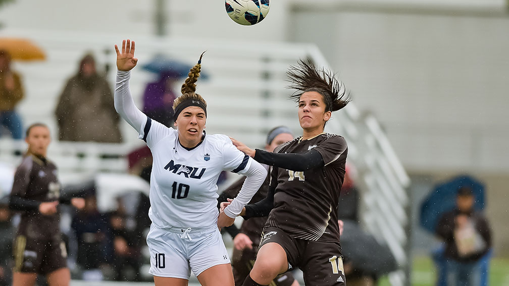 Bison defender Haydn Burdeny duels with Cougar forward Erin Holt on Sunday. Manitoba lost 3-0.