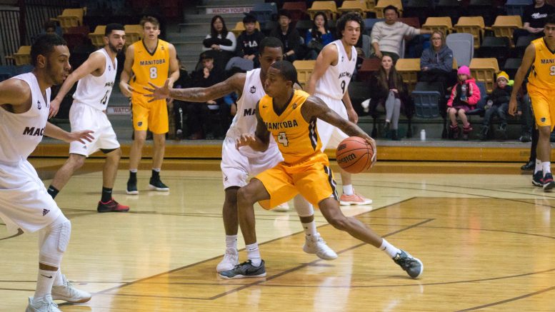 Rashawn Browns of the Bisons drives to the net against the MacEwan Griffins.