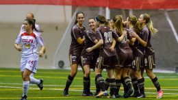 Bisons celebrate a goal in their 5-1 drubbing of the Guelph Gryphons in the consolation semifinal.