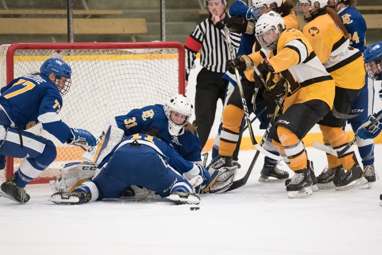 Bison forward Lauryn Keen rushes for loose puck possession as UBC’s goalie Tory Micklash, Emily Costales and Jenna Fletcher attempt to defend on Saturday, Dec. 2 at the Wayne Fleming Arena. Manitoba won 2-1.