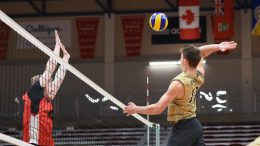 Bison captain Dustin Spiring (#12) goes for a kill as a Wesmen attempts to block at the 27th Annual Duckworth Challenge at the Dr David F. Anderson Gymnasium, University of Winnipeg, on Jan. 18.