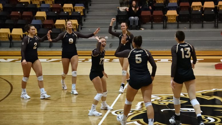 The Bison women's volleyball team celebrate after winning a point against the UBC Okanagan Heat on Feb. 17 at the Investors Group Athletic Centre in Winnipeg.