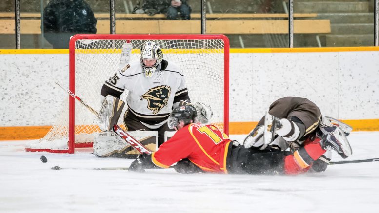 Bison goalie Byron Spriggs makes a save against Calgary.