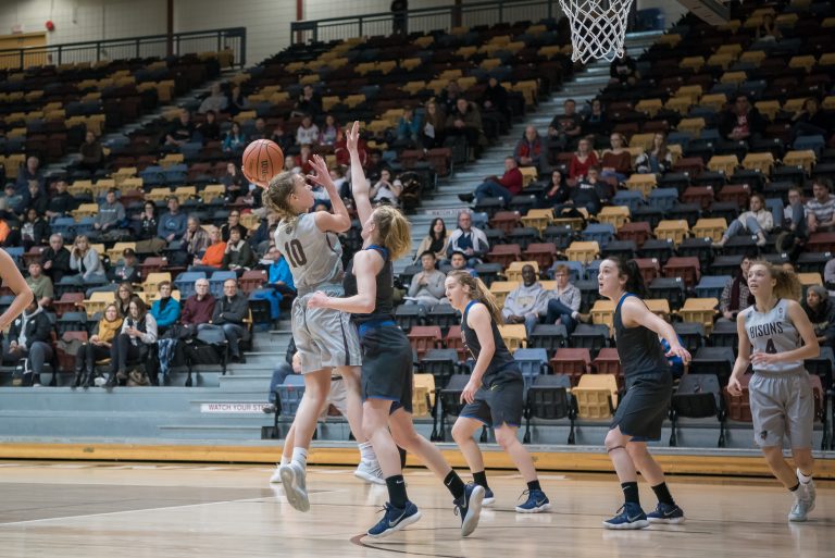Bison Nicole Konieczny (#10) drives up and into defending Vikes guard Aleah Ashlee (#8) for the shot on Saturday, Jan. 13, at the Investors Group Athletic Centre.