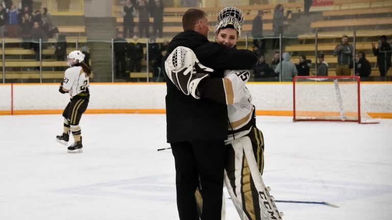 Canada West Rookie of the Year Lauren Taraschuk embraces Canada West Coach of the Year Jon Rempel after being the Saskatchewan Huskies in game two of the Canada West Final on March 3.